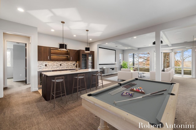 recreation room featuring dark colored carpet, beam ceiling, pool table, and sink