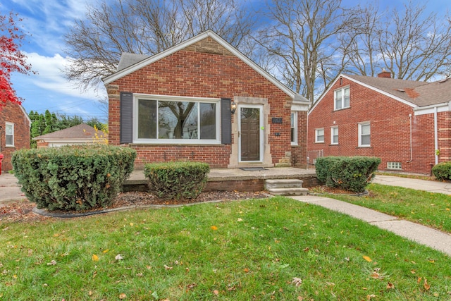 bungalow-style house with a front lawn