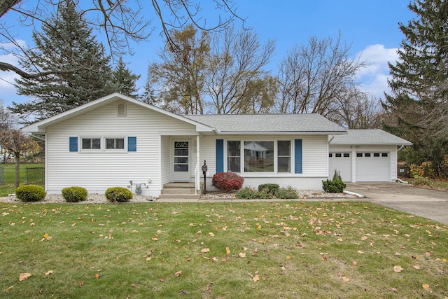 ranch-style home featuring a garage and a front lawn