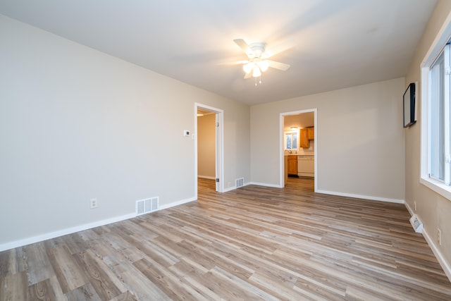 empty room featuring ceiling fan and light hardwood / wood-style floors