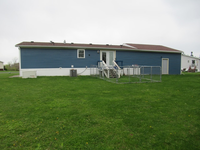 rear view of property featuring a lawn