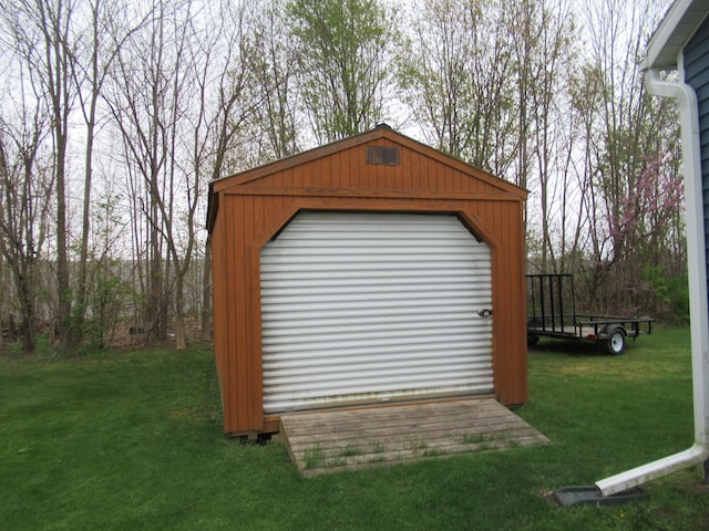 view of outdoor structure featuring a yard and a garage