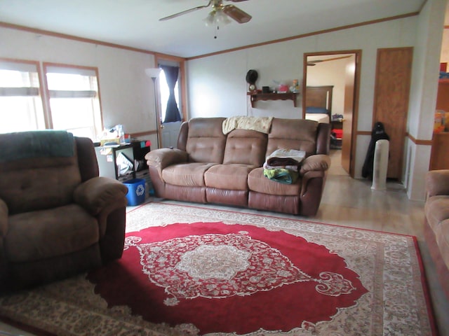 living room with hardwood / wood-style flooring, ceiling fan, and ornamental molding