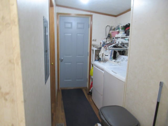 washroom featuring independent washer and dryer, ornamental molding, and wood-type flooring