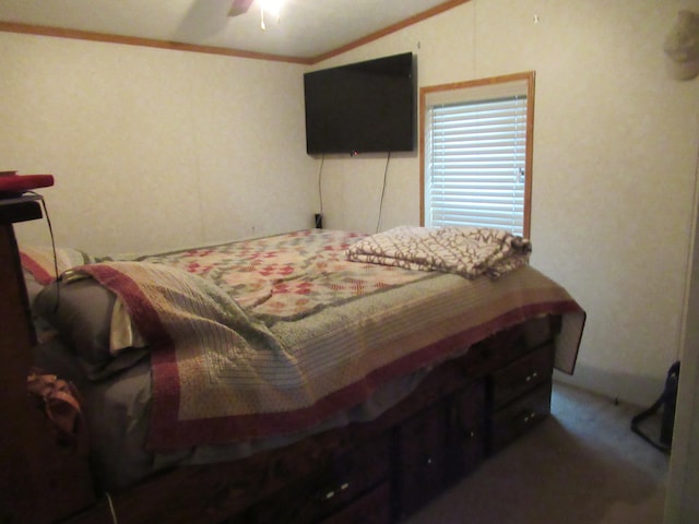 carpeted bedroom with ceiling fan, crown molding, and vaulted ceiling