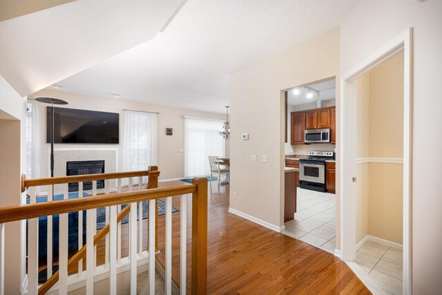 corridor with light hardwood / wood-style flooring