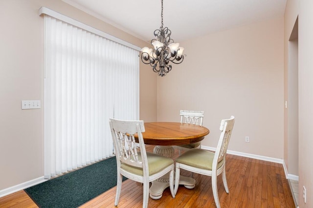 dining space featuring a chandelier and hardwood / wood-style flooring