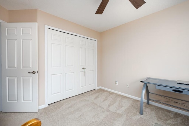 carpeted bedroom with ceiling fan and a closet