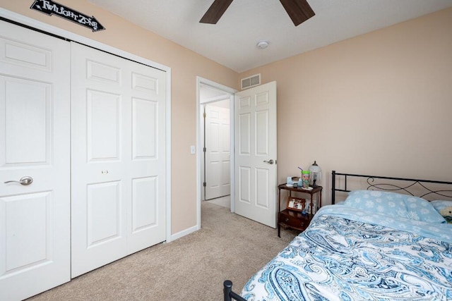 bedroom with light carpet, a closet, and ceiling fan