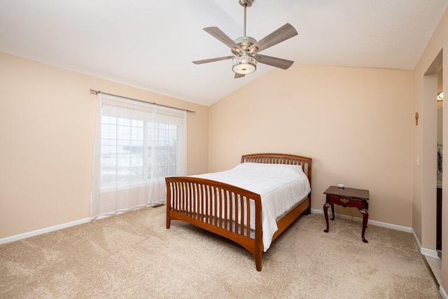 carpeted bedroom with ceiling fan and vaulted ceiling