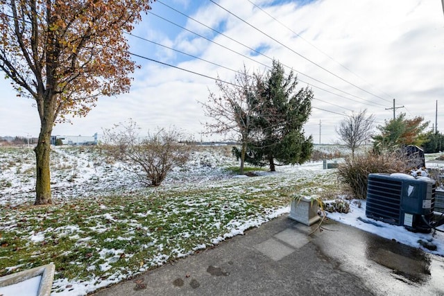 yard covered in snow with cooling unit