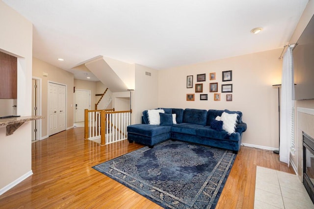 living room featuring a fireplace and wood-type flooring