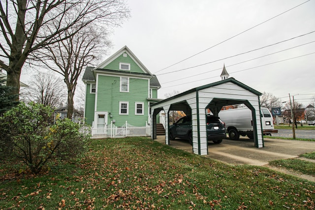 exterior space featuring a carport and a lawn