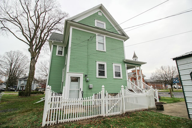 back of house with a lawn