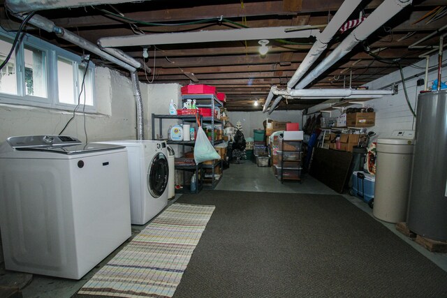 clothes washing area featuring washing machine and dryer and water heater