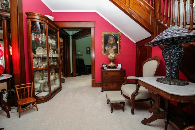 living area featuring light colored carpet and lofted ceiling