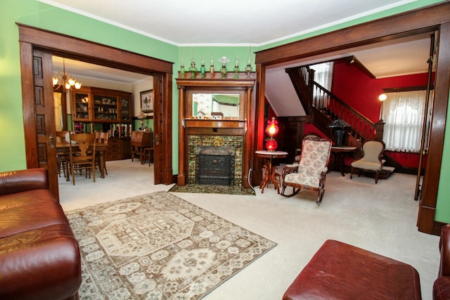 living room featuring carpet flooring, a chandelier, a brick fireplace, and crown molding