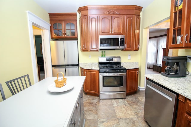 kitchen featuring light stone counters and stainless steel appliances