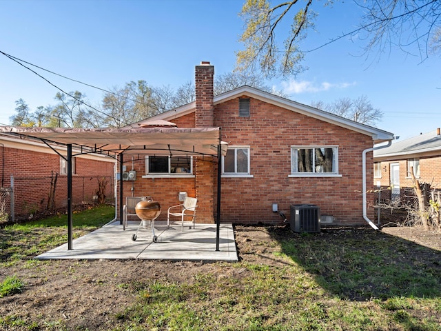 back of property with a patio, a pergola, central AC, and a lawn