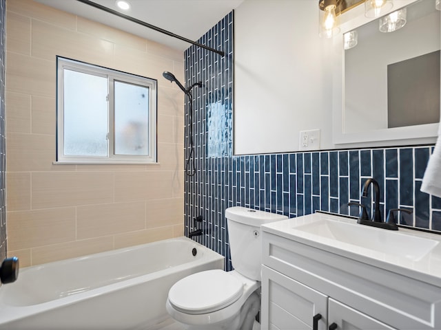 full bathroom with tasteful backsplash, vanity, tile walls, toilet, and tiled shower / bath