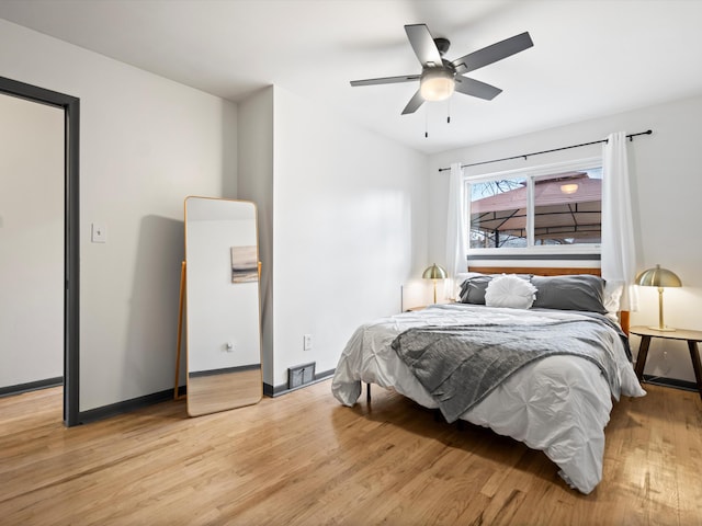 bedroom with light hardwood / wood-style flooring and ceiling fan