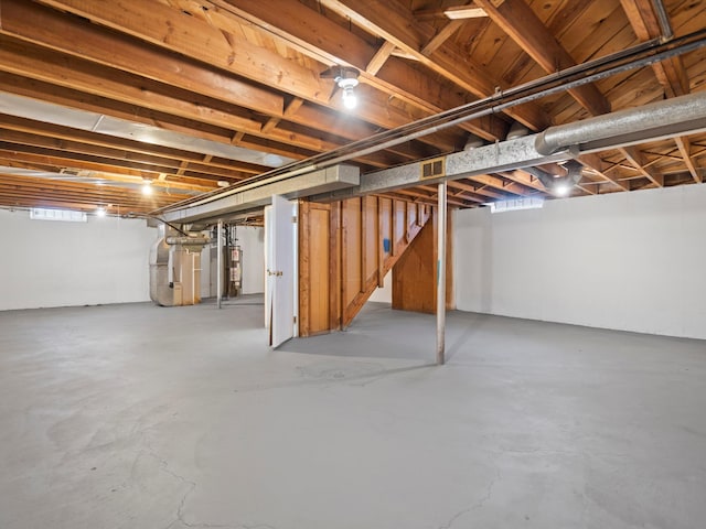 basement featuring heating unit and gas water heater