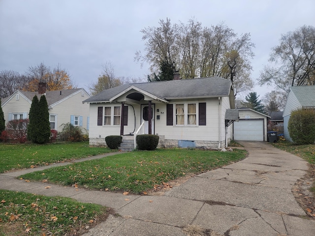 view of front of property featuring an outbuilding, a garage, and a front lawn