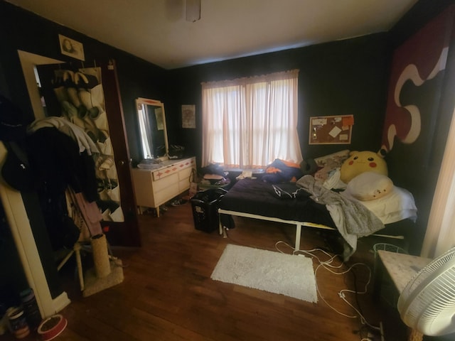 bedroom with dark hardwood / wood-style flooring