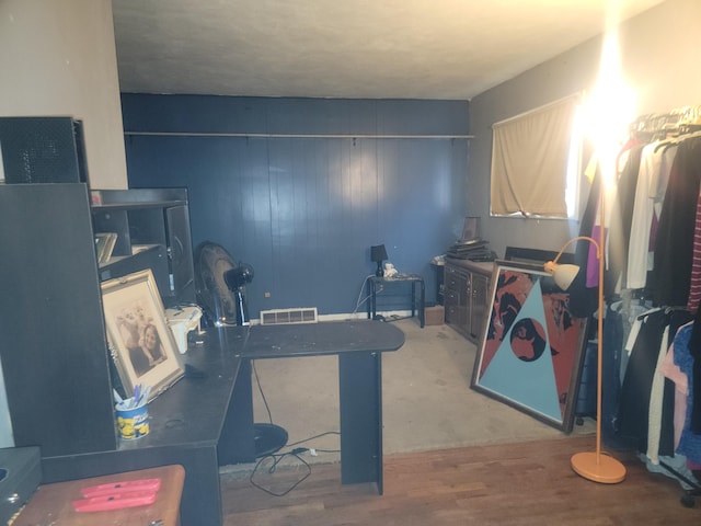 interior space featuring hardwood / wood-style floors and wood walls