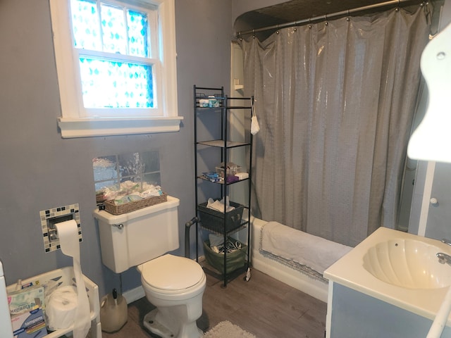 bathroom featuring hardwood / wood-style floors, vanity, toilet, and walk in shower