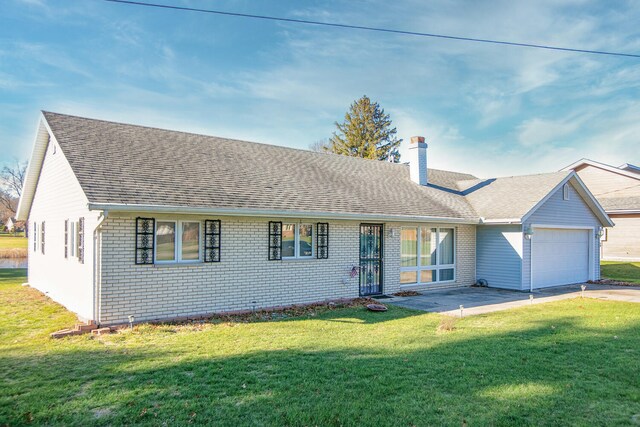 ranch-style house featuring a garage and a front lawn