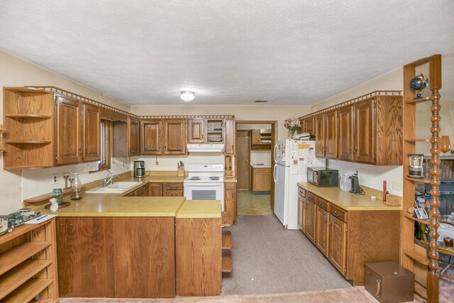 kitchen with sink, kitchen peninsula, a textured ceiling, white appliances, and light carpet