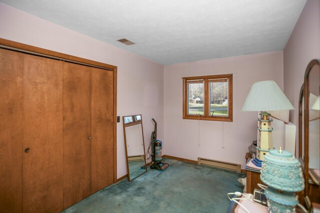 misc room with a textured ceiling, carpet floors, and a baseboard radiator