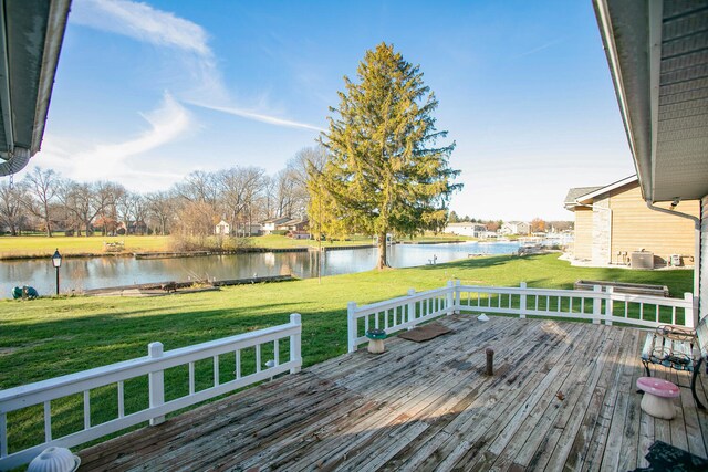 deck featuring a yard, a water view, and central AC unit