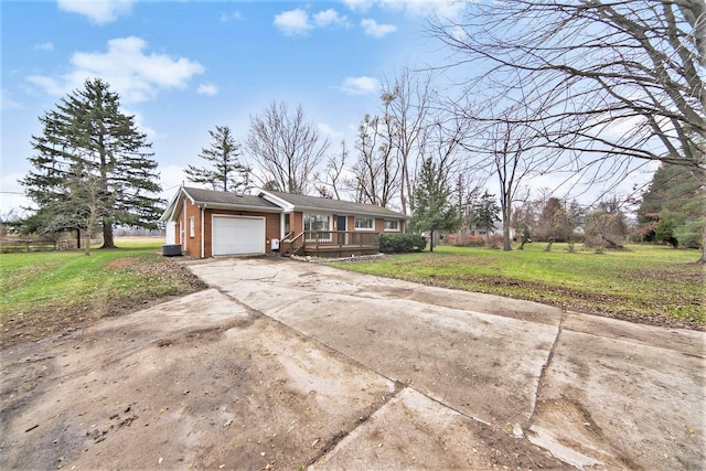 ranch-style home with a garage and a front lawn