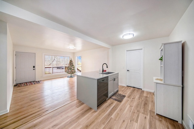 kitchen with sink, light hardwood / wood-style flooring, gray cabinets, dishwasher, and a kitchen island with sink