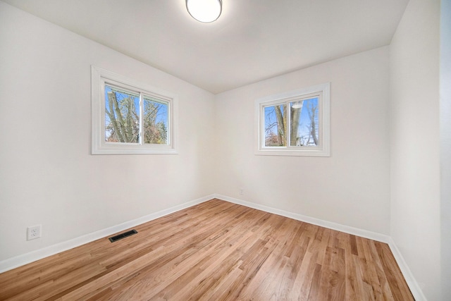 spare room with light hardwood / wood-style floors