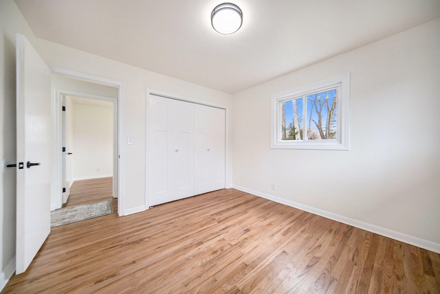 unfurnished bedroom with light hardwood / wood-style floors and a closet