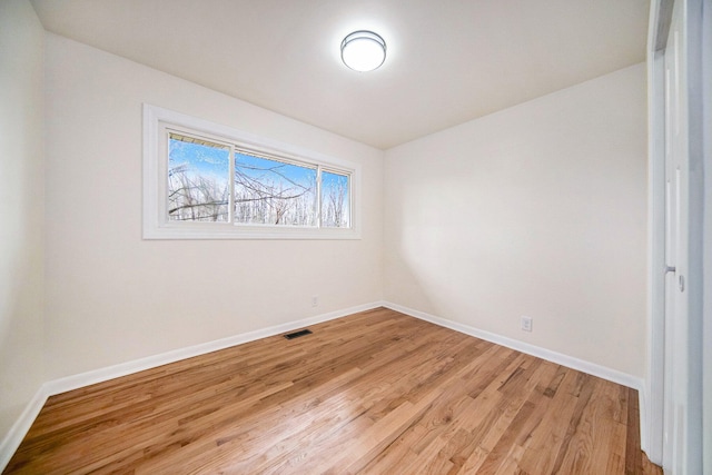 spare room featuring hardwood / wood-style floors