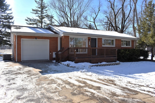 single story home with a garage and central air condition unit