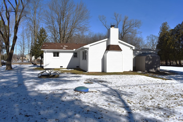 snow covered house with a shed