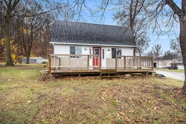 view of front of house featuring a front yard and a deck