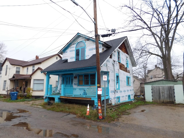 view of front facade with a storage unit and covered porch