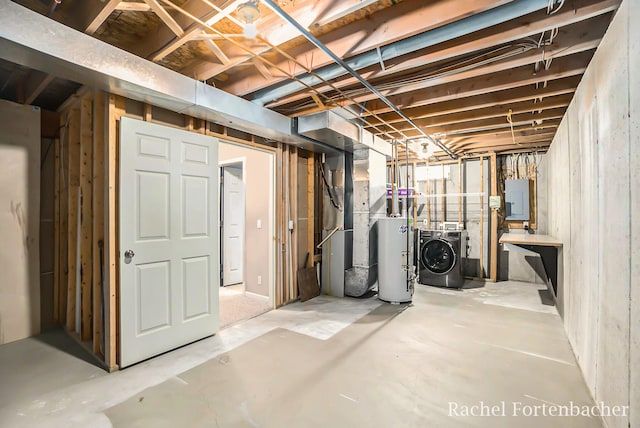 basement with electric panel, gas water heater, heating unit, and washing machine and clothes dryer