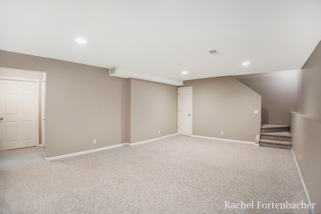 basement featuring light colored carpet