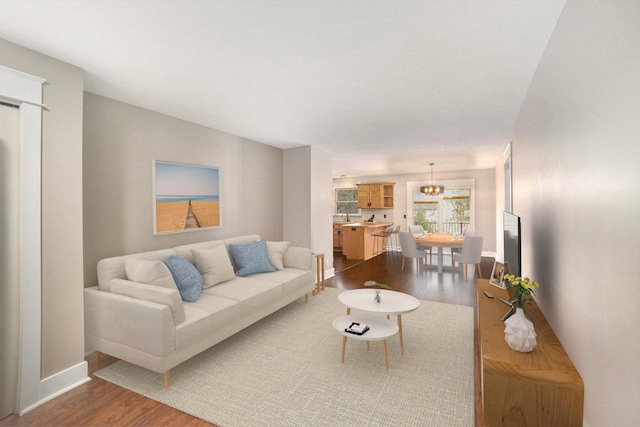 living room with hardwood / wood-style floors and sink