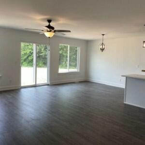 spare room with dark hardwood / wood-style floors and ceiling fan