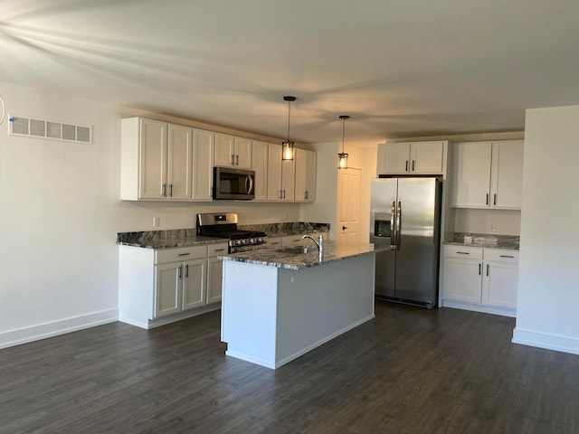 kitchen featuring appliances with stainless steel finishes, decorative light fixtures, white cabinetry, and dark wood-type flooring