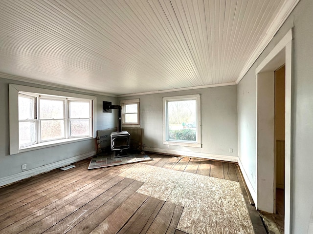 unfurnished living room featuring wood ceiling, a wood stove, wood-type flooring, and ornamental molding