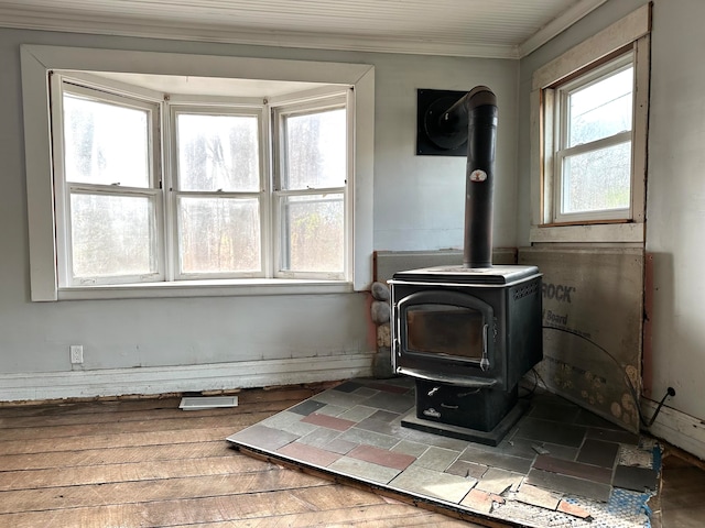 details featuring hardwood / wood-style flooring, a wood stove, and ornamental molding